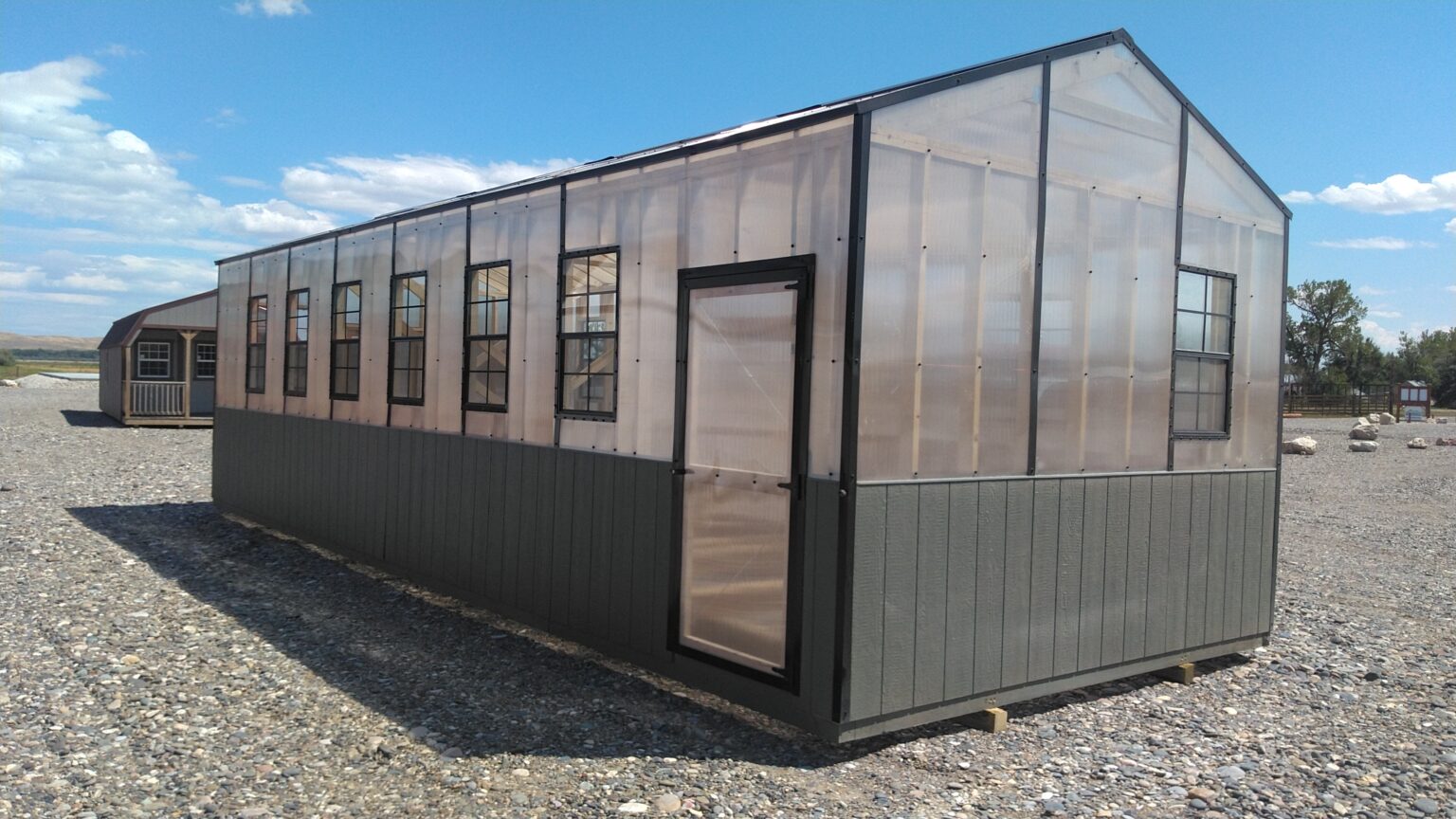 Green and clear 12x32 polycarbonate greenhouse.
