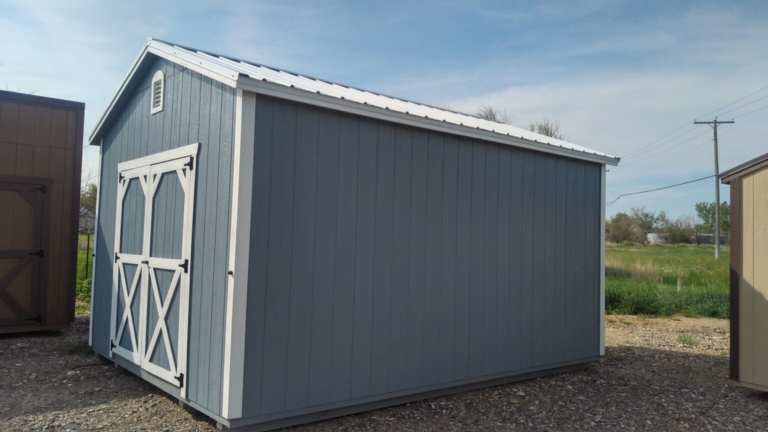 Light gray and white 12x16 garden shed.