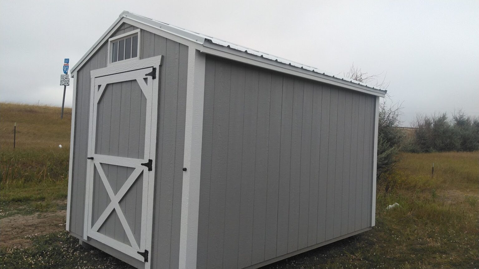 Light gray and white 8x12 garden shed.