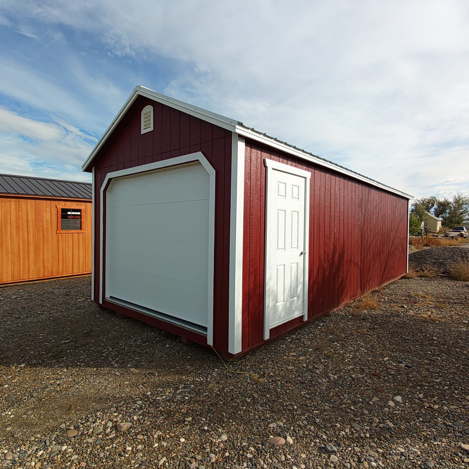 Red and white 12x28 A-frame garage.